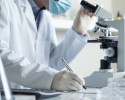 Researcher using microscope